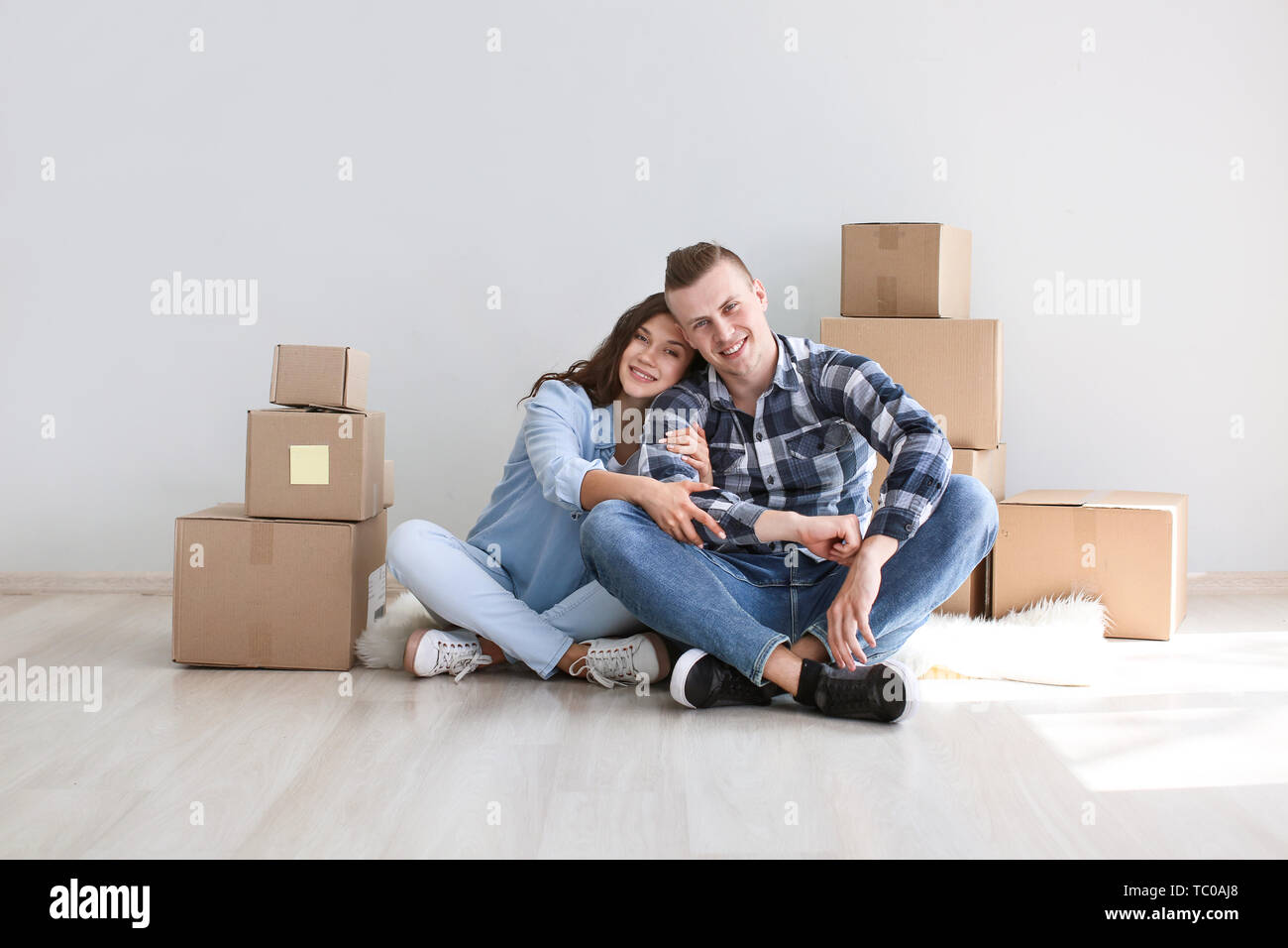 Adorable loving couple after moving into new house Stock Photo - Alamy