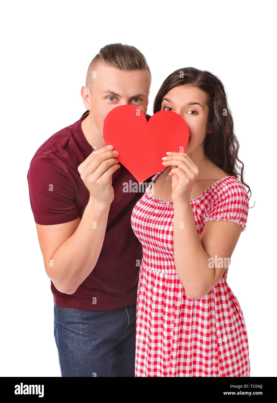 Adorable loving couple with paper heart on white background Stock Photo ...