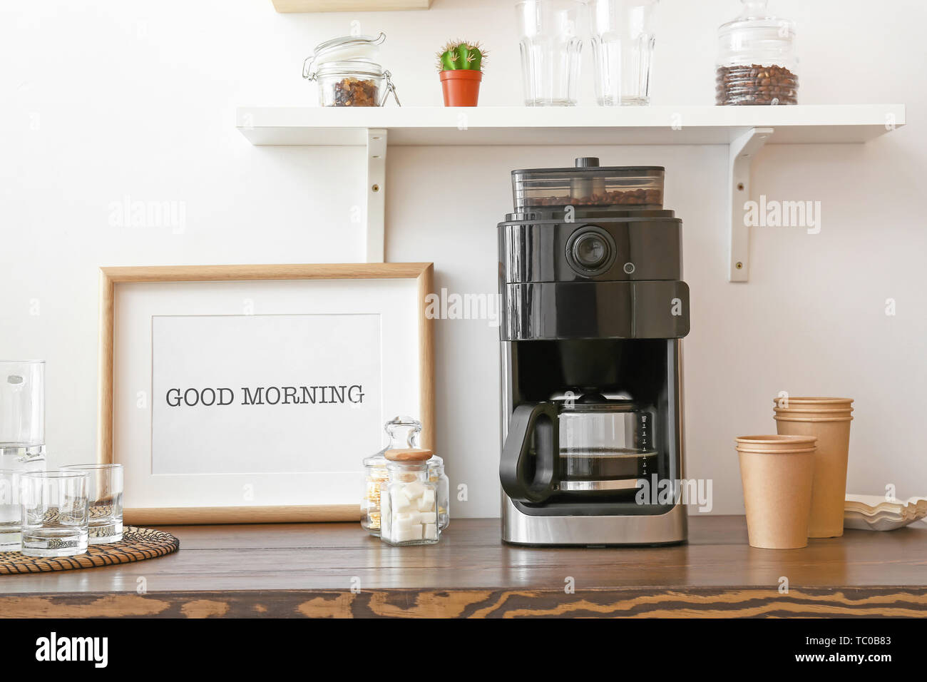 Modern coffee machine on kitchen table 