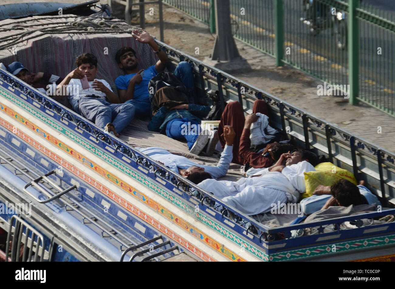 Lahore, Pakistan. 03rd June, 2019. Passengers travel on the rooftop of a passenger bus as they travel to their home towns to celebrate the Eid with their loved ones ahead of the Eid al-Fitr festival. Millions of Muslims around the world are preparing to celebrate the Eid festival, marking the end of the fasting month of Ramadan. Credit: Rana Sajid Hussain/Pacific Press/Alamy Live News Stock Photo