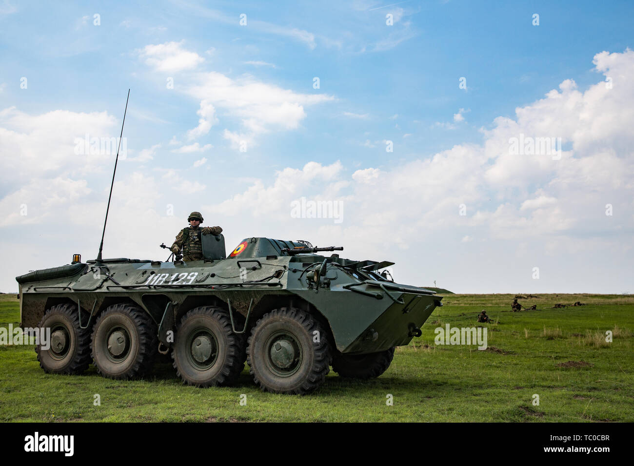 A Romanian soldier with the 631st Tank Battalion mounted in a TAB-77 personnel carrier surveys the area during a force on force exercise as part of Justice Eagle on a range near Smardan Training Area, Romania May 30, 2019. Justice Eagle, a combined bilateral exercise with Romanian allies, demonstrates the interoperability of NATO allies during Atlantic Resolve. (U.S. Army Photo by Sgt. Jeremiah Woods) Stock Photo