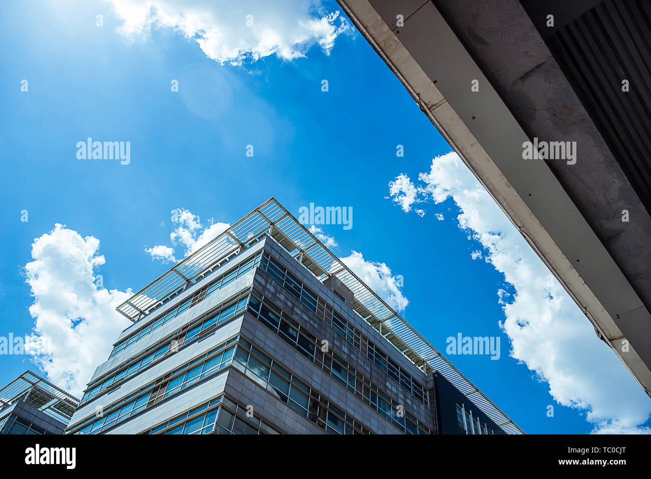 Buildings under blue sky and white clouds Stock Photo - Alamy