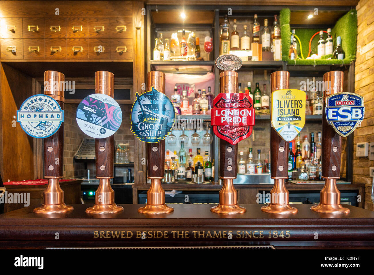 Beer pumps on a bar in an English pub in London, UK Stock Photo