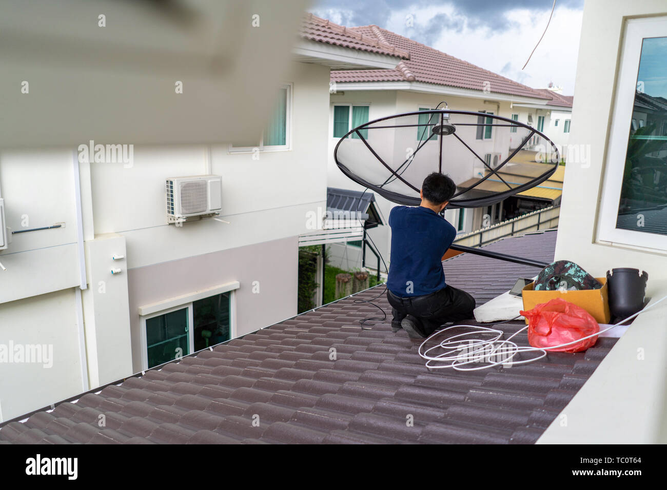 Worker install and set up the digital TV satellite dish on the ...