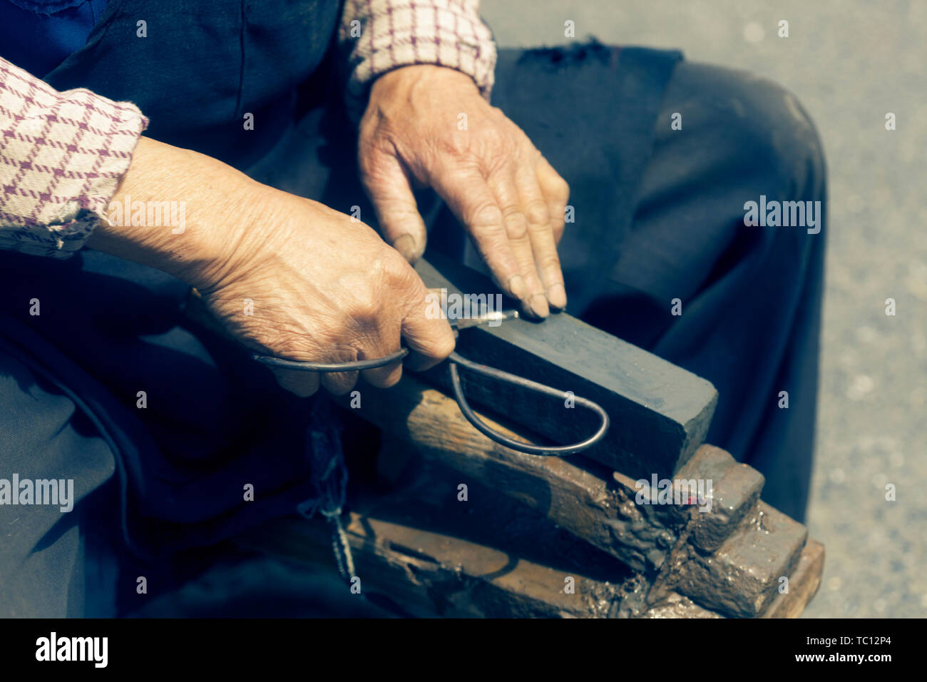 craftsman sharpen scissor with whetstone Stock Photo Alamy