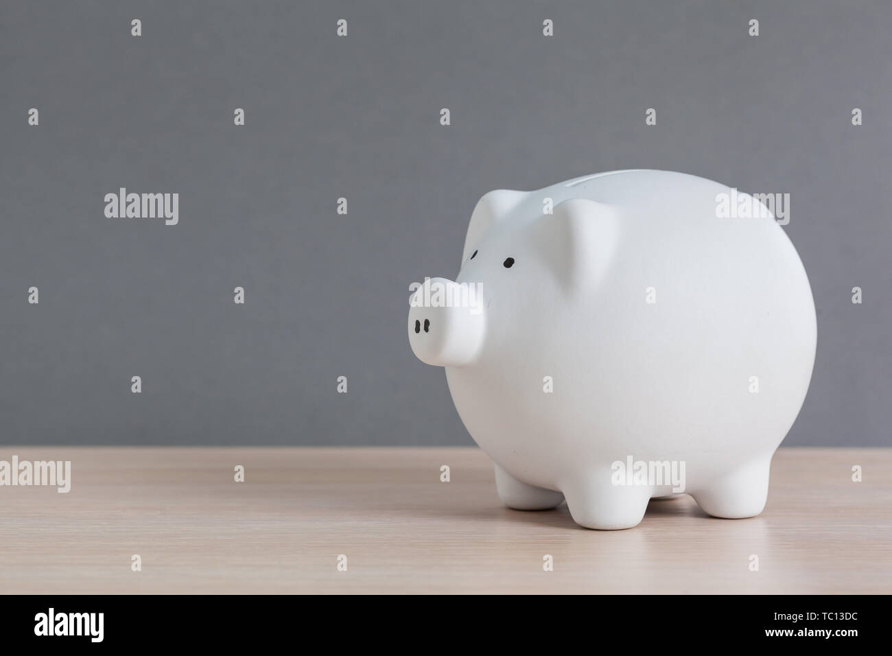 Piggy bank on wooden table Stock Photo - Alamy