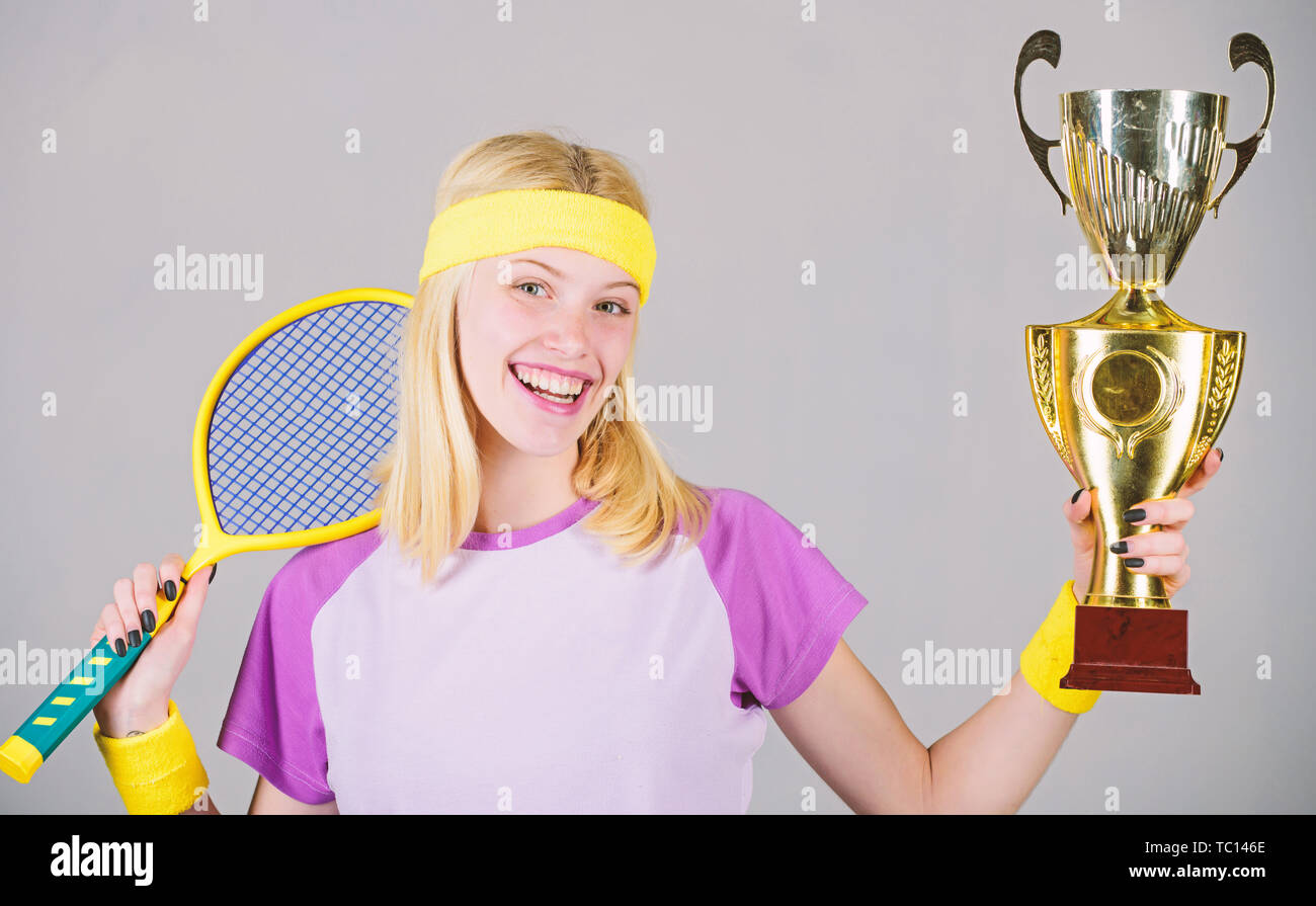 Woman wear sport outfit. First place. Sport achievement. Celebrate victory. Tennis  champion. Athletic girl hold tennis racket and golden goblet. Win tennis  game. Tennis player win championship Stock Photo - Alamy