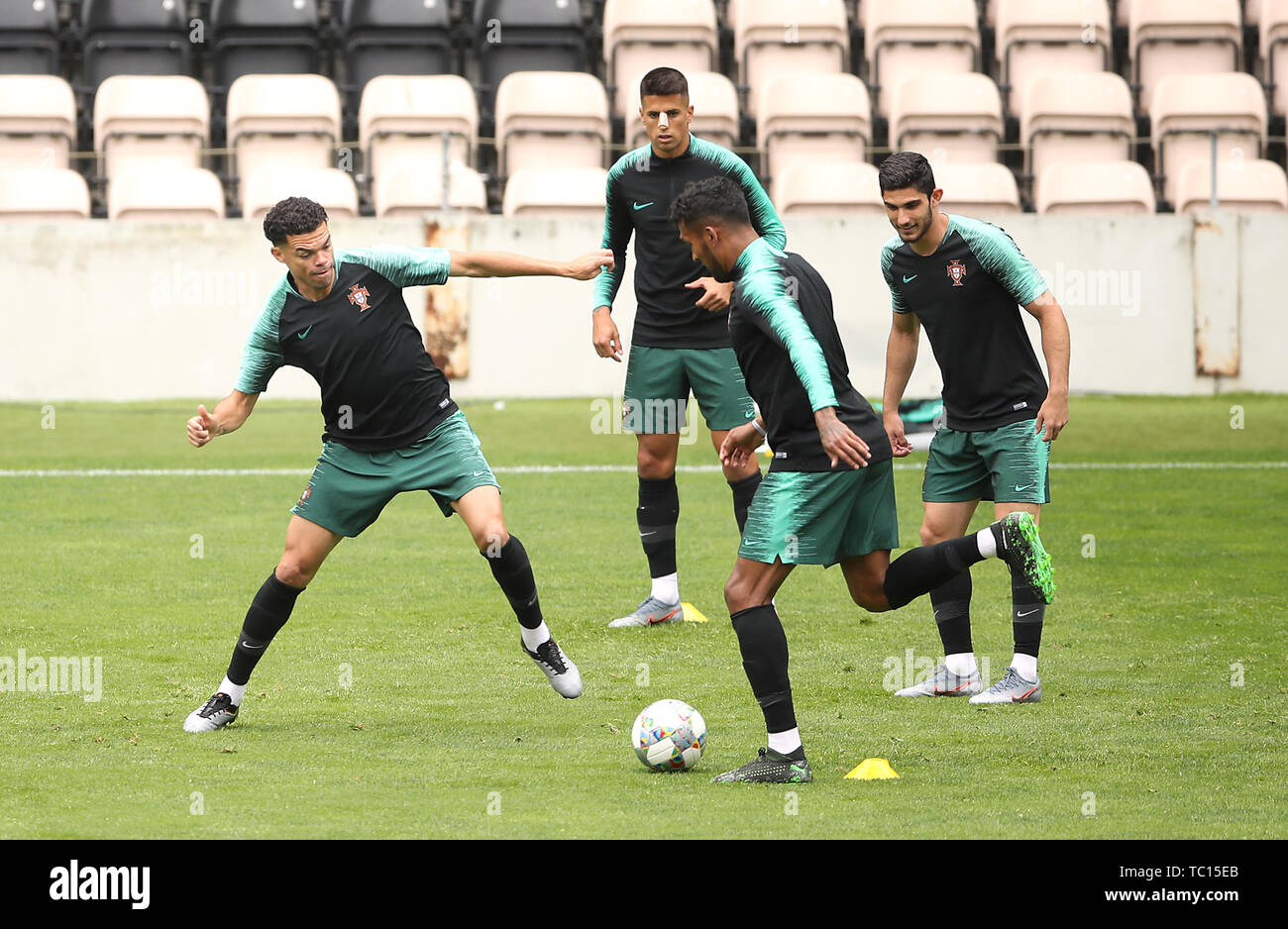Portugal's Pepe (left) and Dyego Sousa battle for the ball as Joao Cancelo (centre) and Goncalo Guedes (right) watches on during the training session at Estadio do Bessa, Porto. Stock Photo