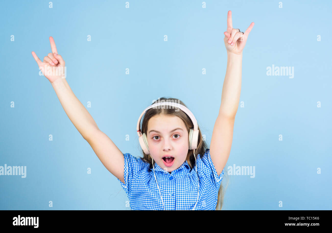 Shes a rock star. Little kid showing horn hand gesture like a hard rock