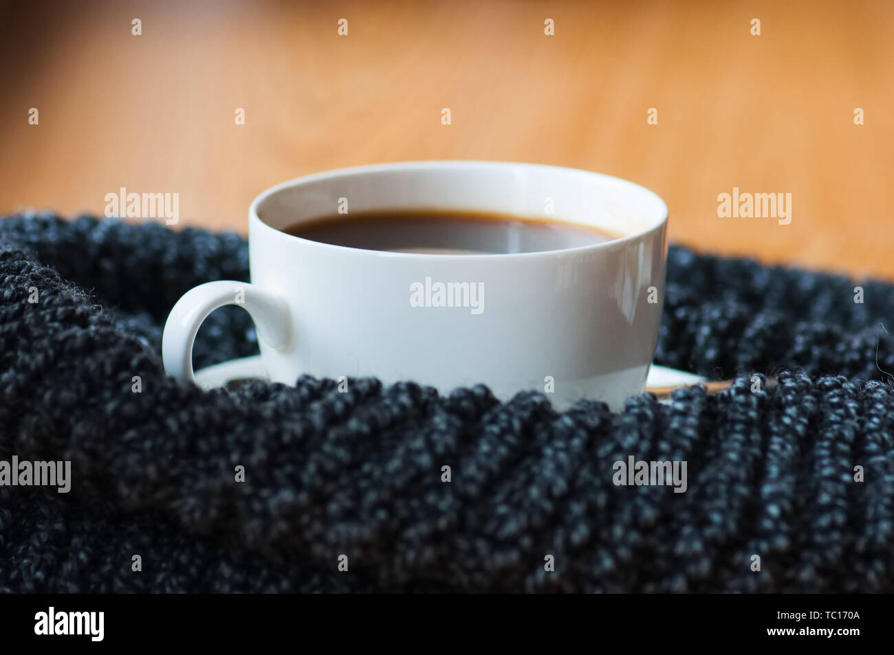Cup of americano and scarf. Close up. Stock Photo