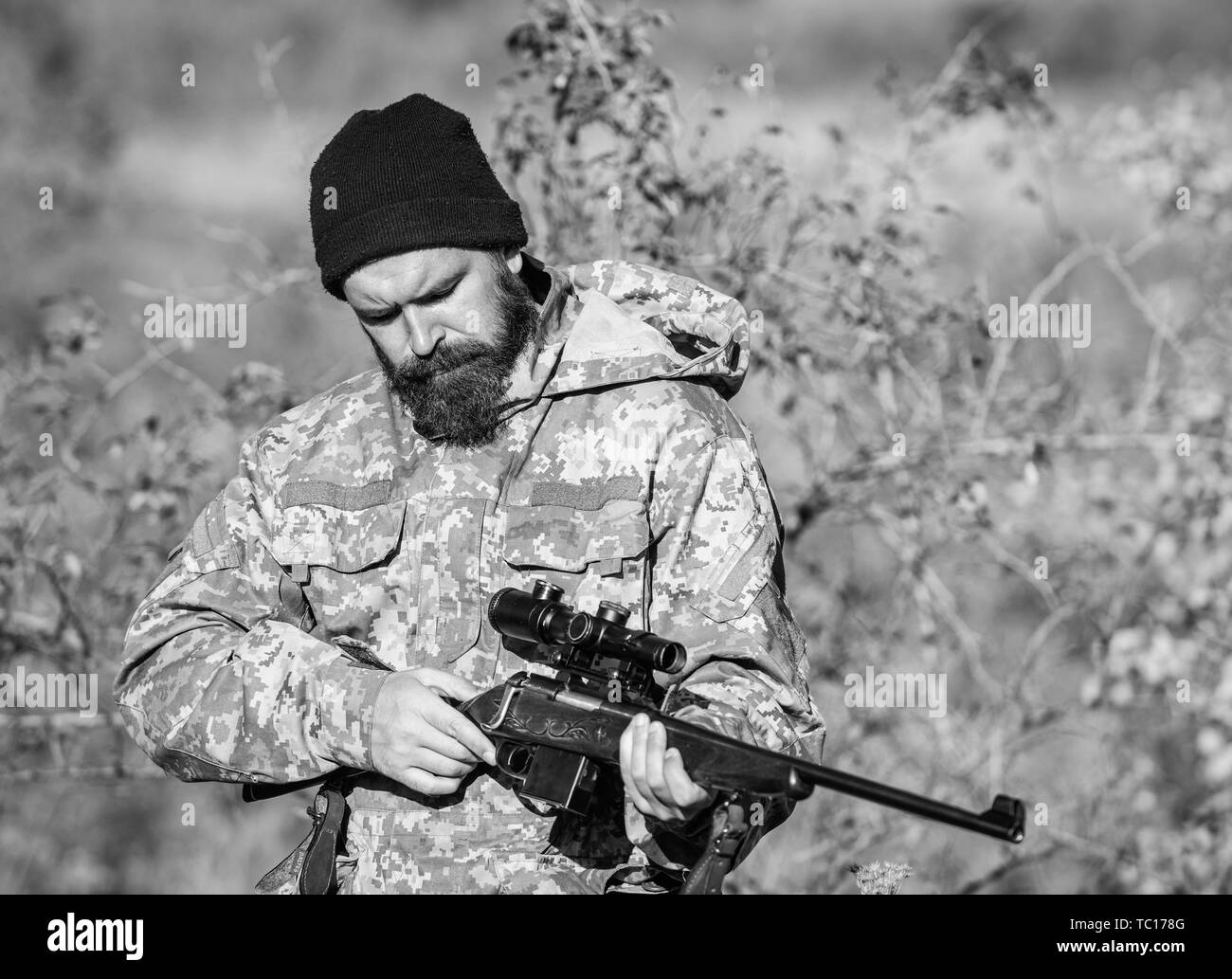 Man hunter with rifle gun. Boot camp. Bearded man hunter. Army forces. Camouflage. Military uniform fashion. Hunting skills and weapon equipment. How turn hunting into hobby. Cowboy with gun. Stock Photo