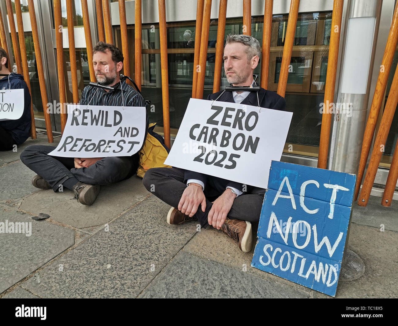 Activists from the Extinction Rebellion Scotland group with locks around their necks who have chained themselves to the Holyrood building with the means of freeing them sent to the leaders of the SNP, Conservatives, Labour, the Scottish Greens and the Liberal Democrats. Stock Photo