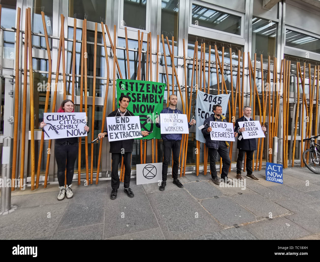 Five activists from the Extinction Rebellion Scotland group with locks around their necks who have chained themselves to the Holyrood building with the means of freeing them sent to the leaders of the SNP, Conservatives, Labour, the Scottish Greens and the Liberal Democrats. Stock Photo