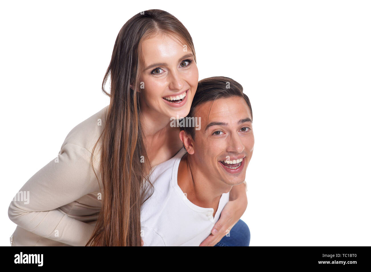 Happy beautiful young couple posing on white background Stock Photo - Alamy