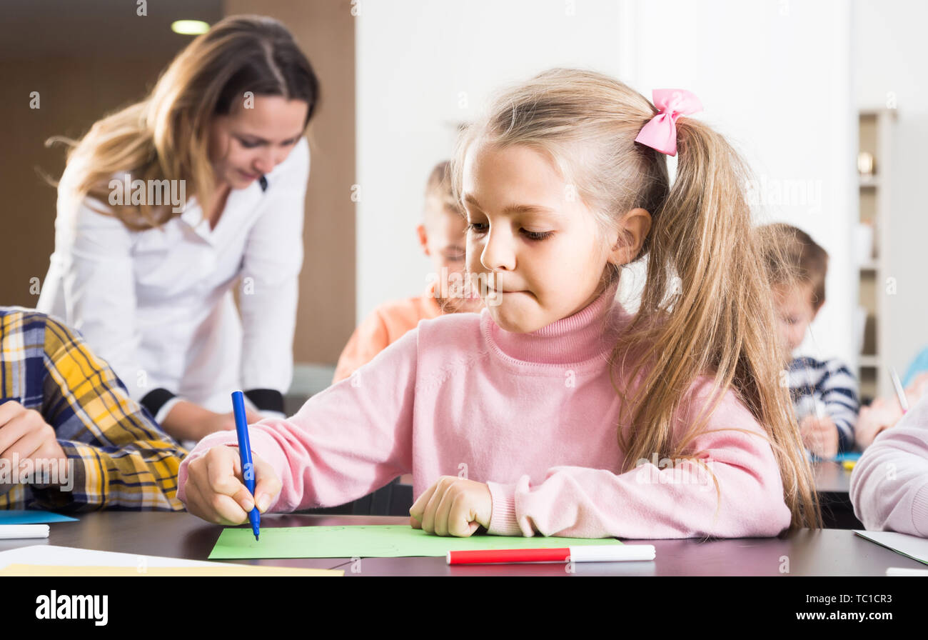 positive children of elementary age having class of art Stock Photo - Alamy