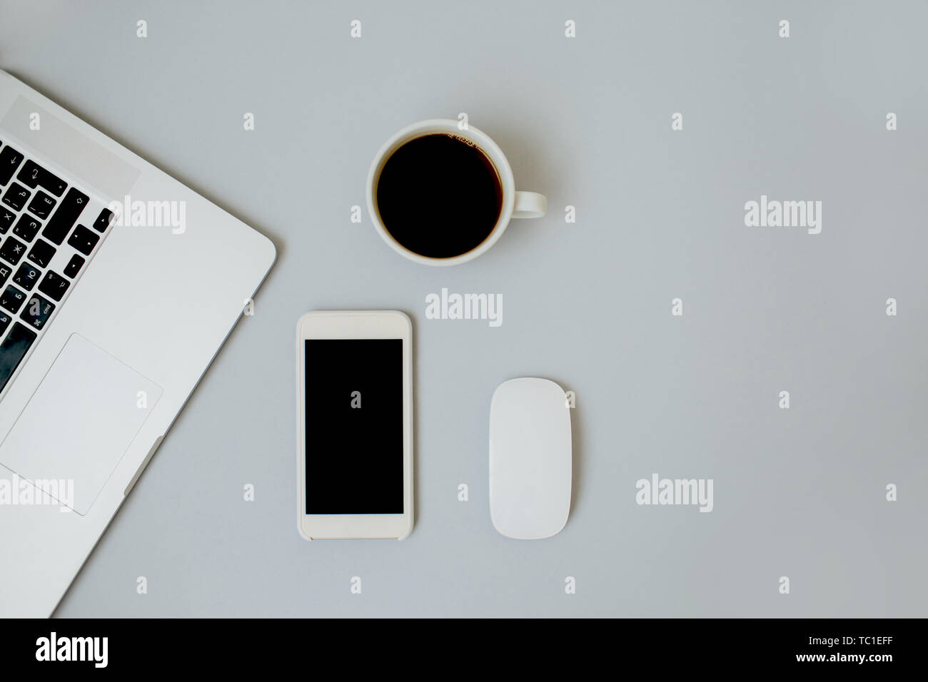 Flatlay composition with laptop keyboard, cup of hot black coffee ...