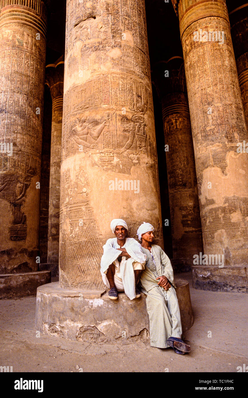 Photo: © Simon Grosset. Two men wait outside Esna Temple, south of Luxor, Egypt. Archive: Image digitised from an original transparency. Stock Photo