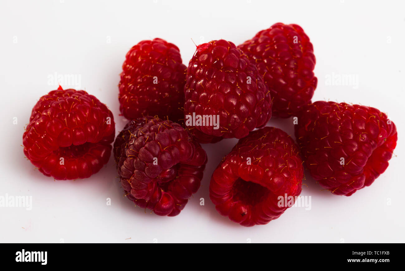 Close up of ripe red raspberries on white surface, nobody Stock Photo ...