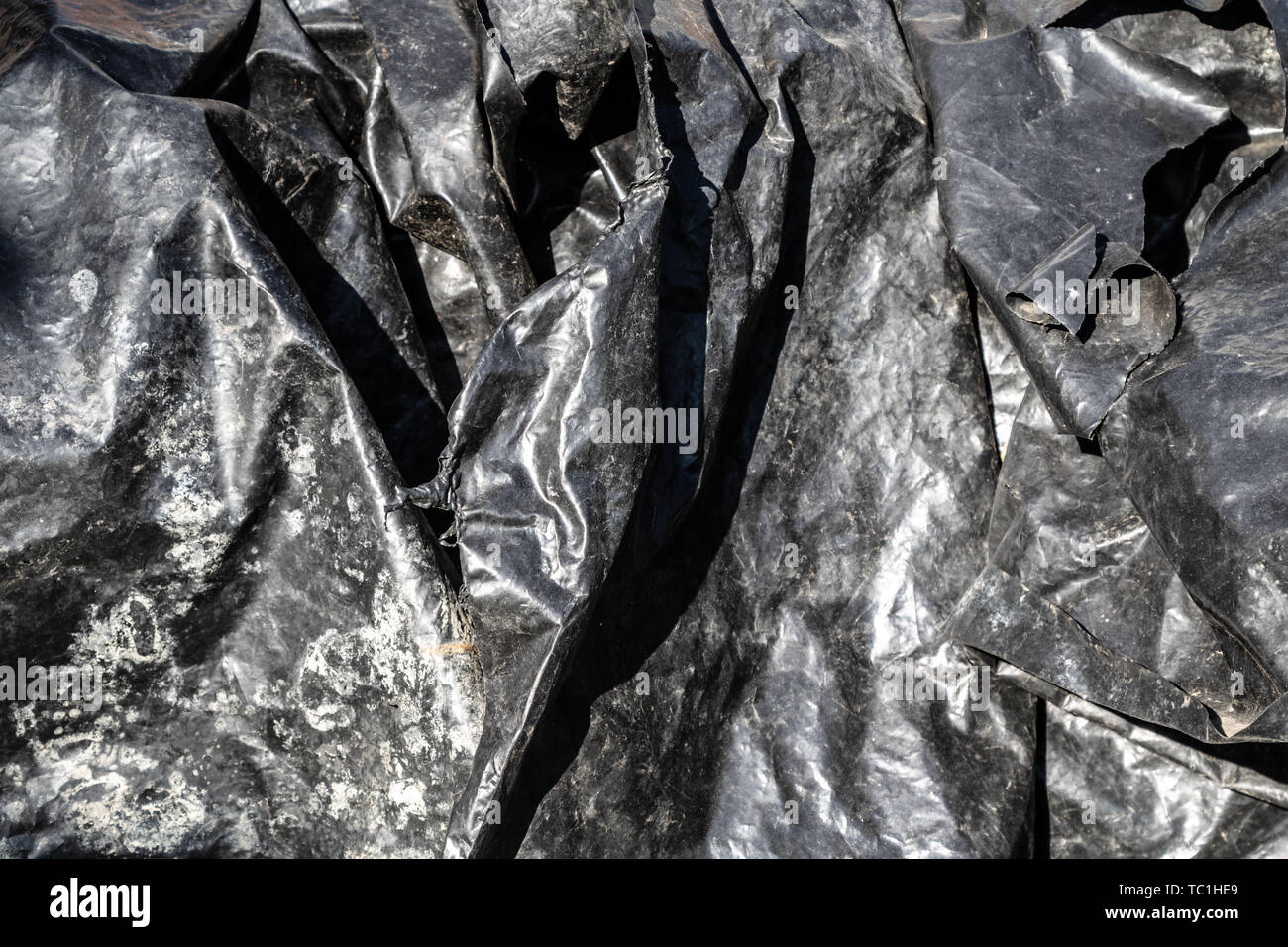 Black foil plastic surface texture Stock Photo