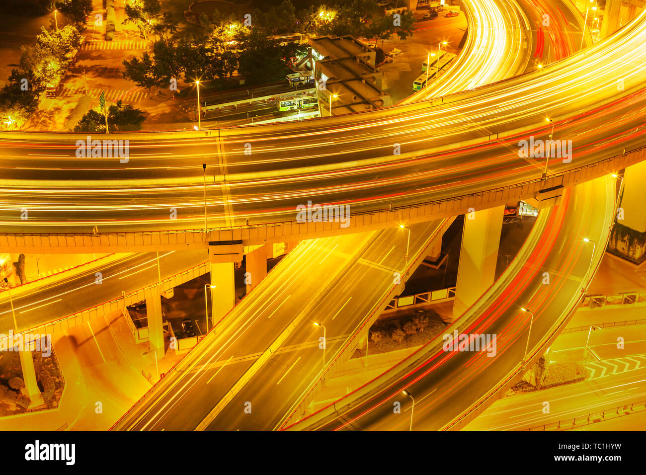 illuminated road intersection and traffic trails Stock Photo - Alamy