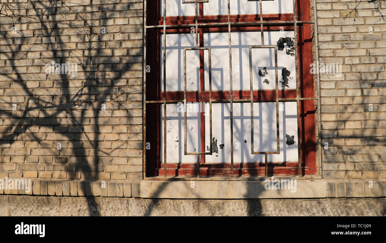 Nostalgic brick walls, mottled tree shadows Stock Photo