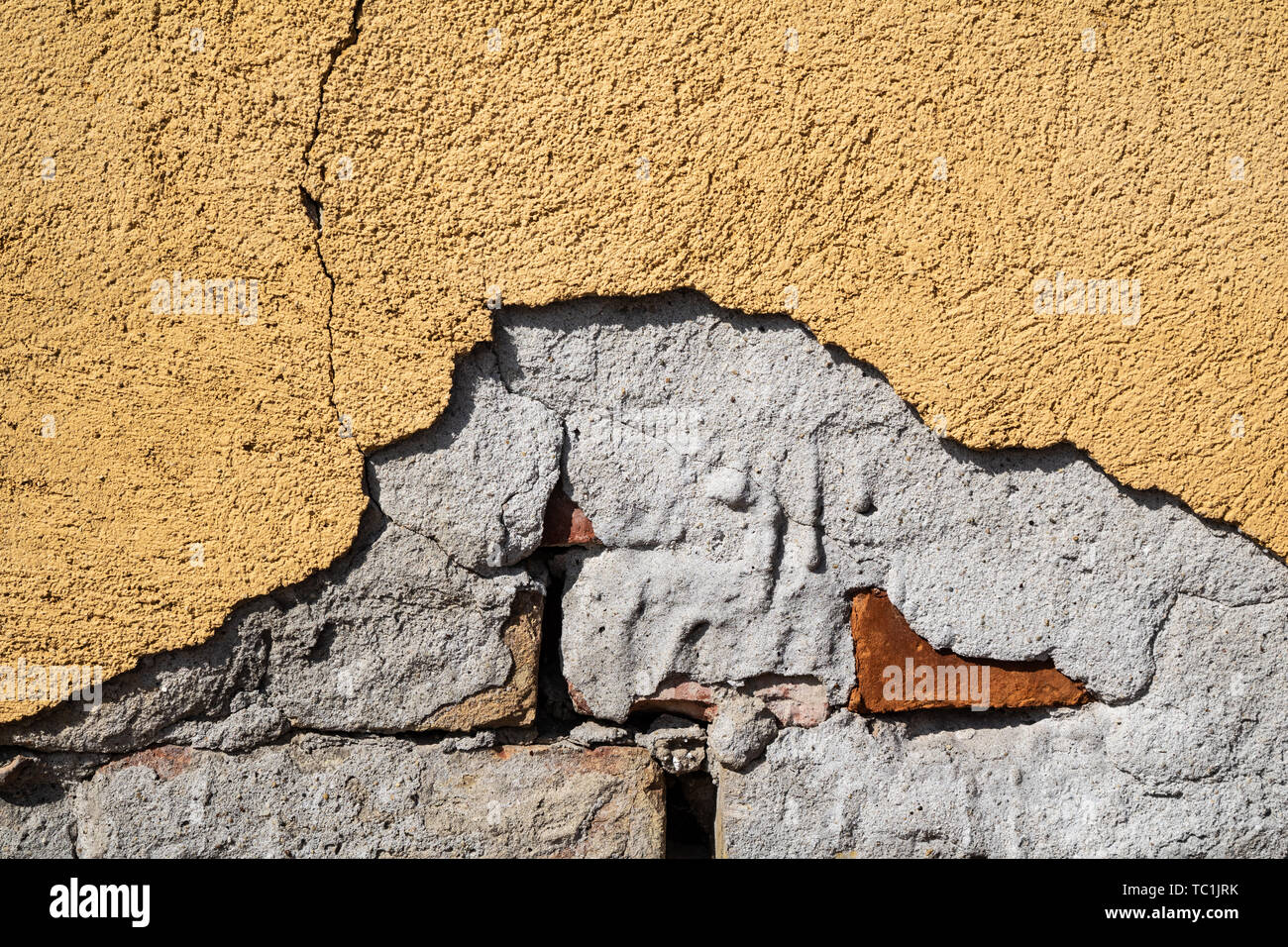 Yellow cracked weathered wall surface texture Stock Photo