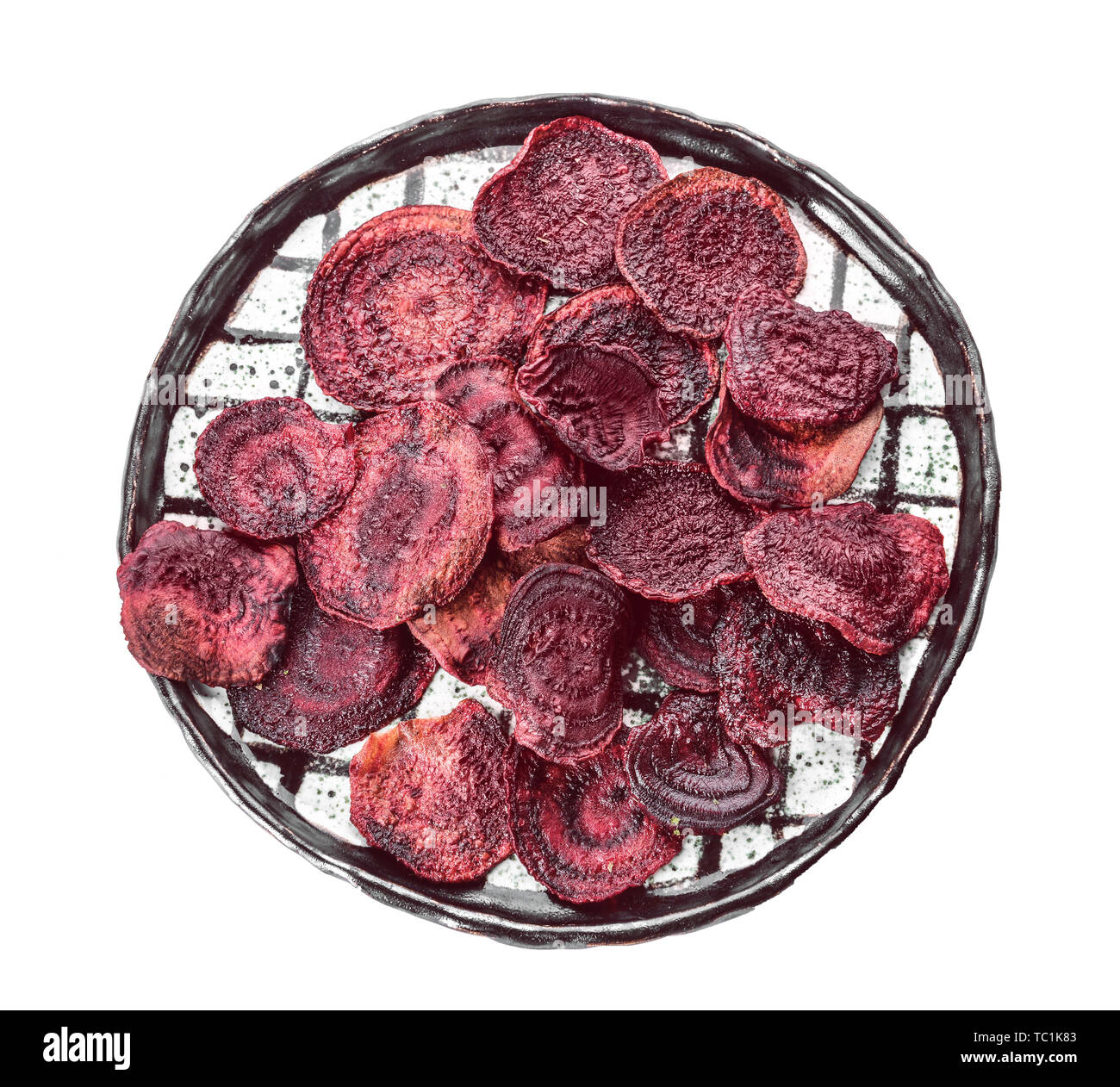 Plate with tasty beet chips on white background Stock Photo