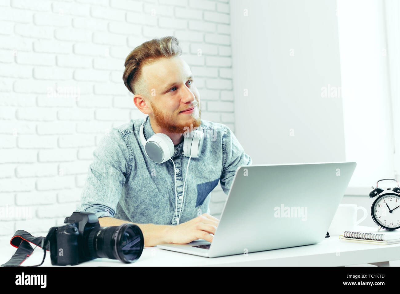 Photographer selecting photos on his computer Stock Photo