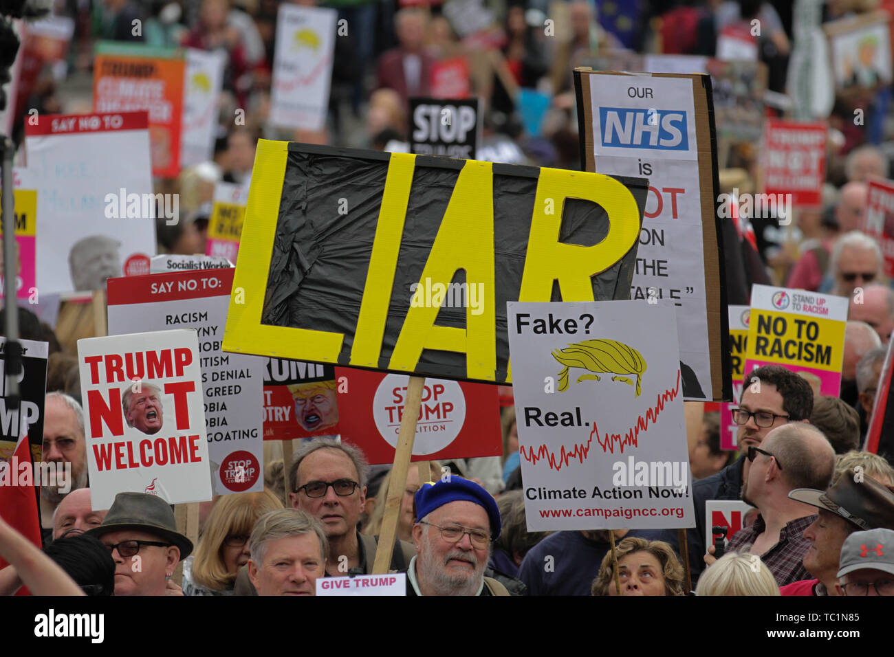 Demonstrators hold placards during the anti-Trump rally on the second day of the state visit of the American president to the UK. Stock Photo