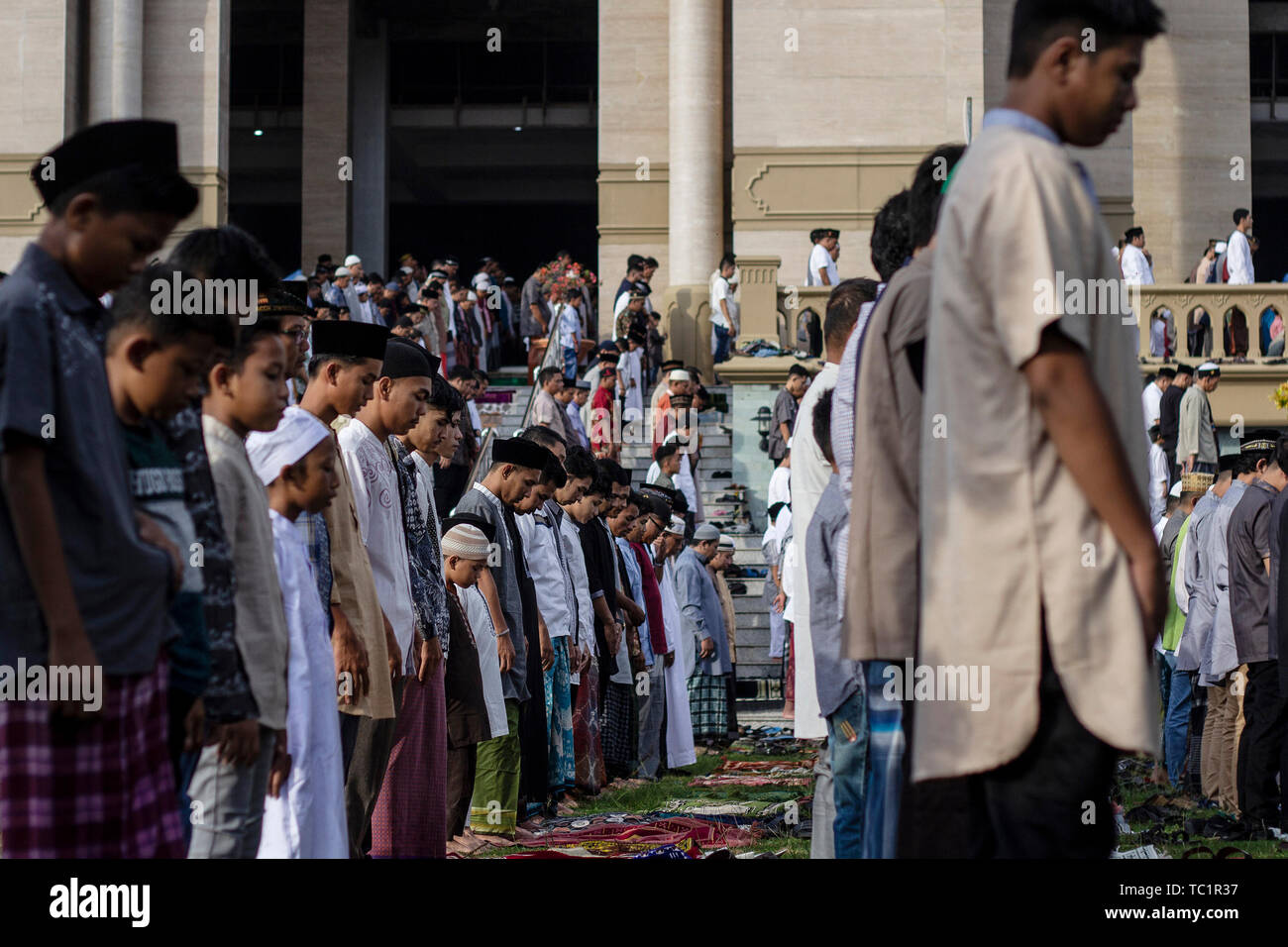 Acehnese Muslims perform Eid al-Fitr prayer in Lhokseumawe.  Muslims around the world celebrate Eid al-Fitr marked by the end of fasting in the holy month of Ramadan. Stock Photo