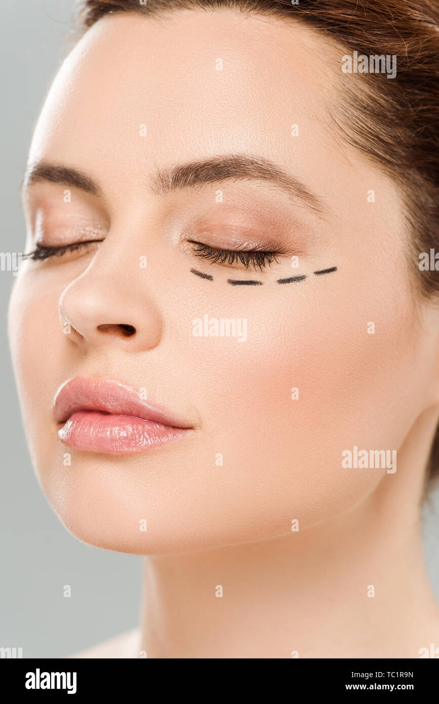 close up view of beautiful woman with closed eyes and marks on face ...