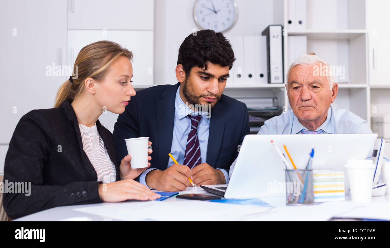 Managers are writing financial reports in the office. Stock Photo