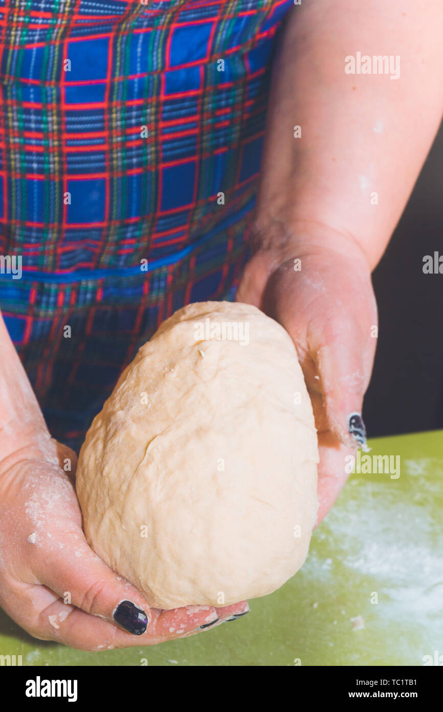 Knead the dough with your hands on the table Stock Photo - Alamy