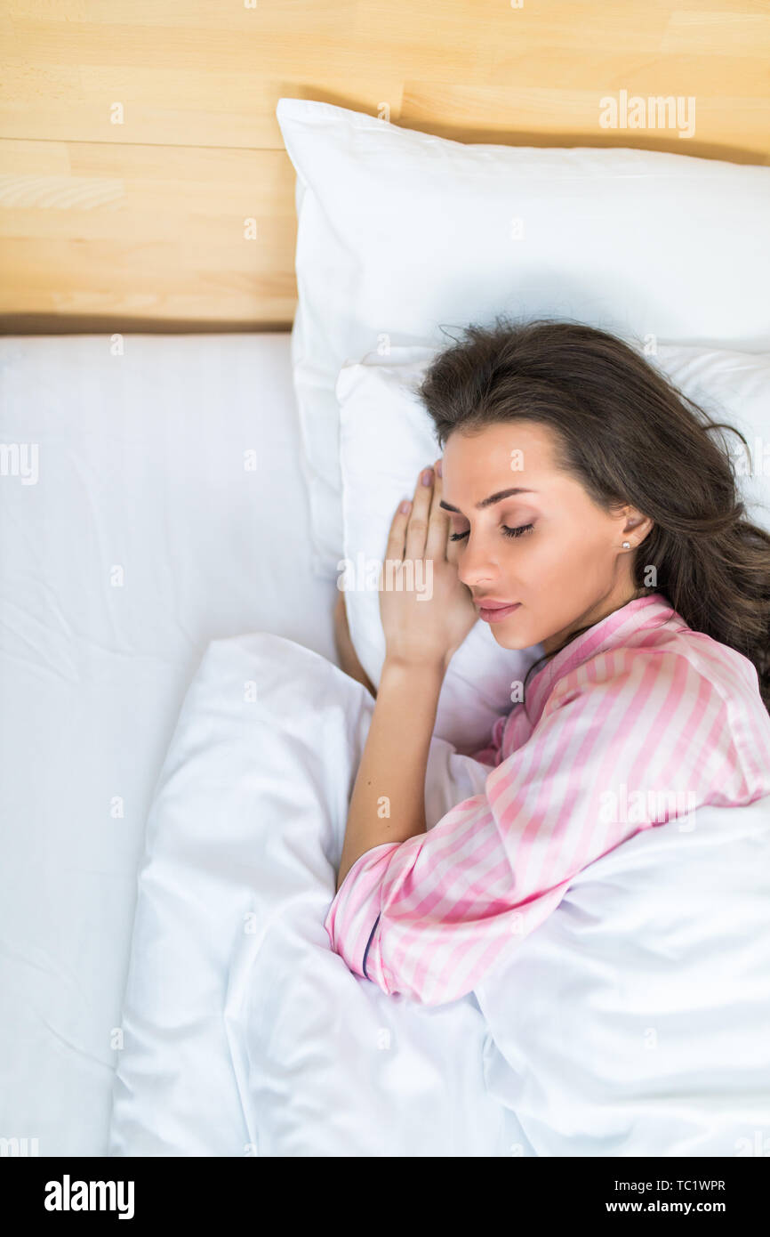 Blonde girl sleeping tight in short pants at home Stock Photo - Alamy