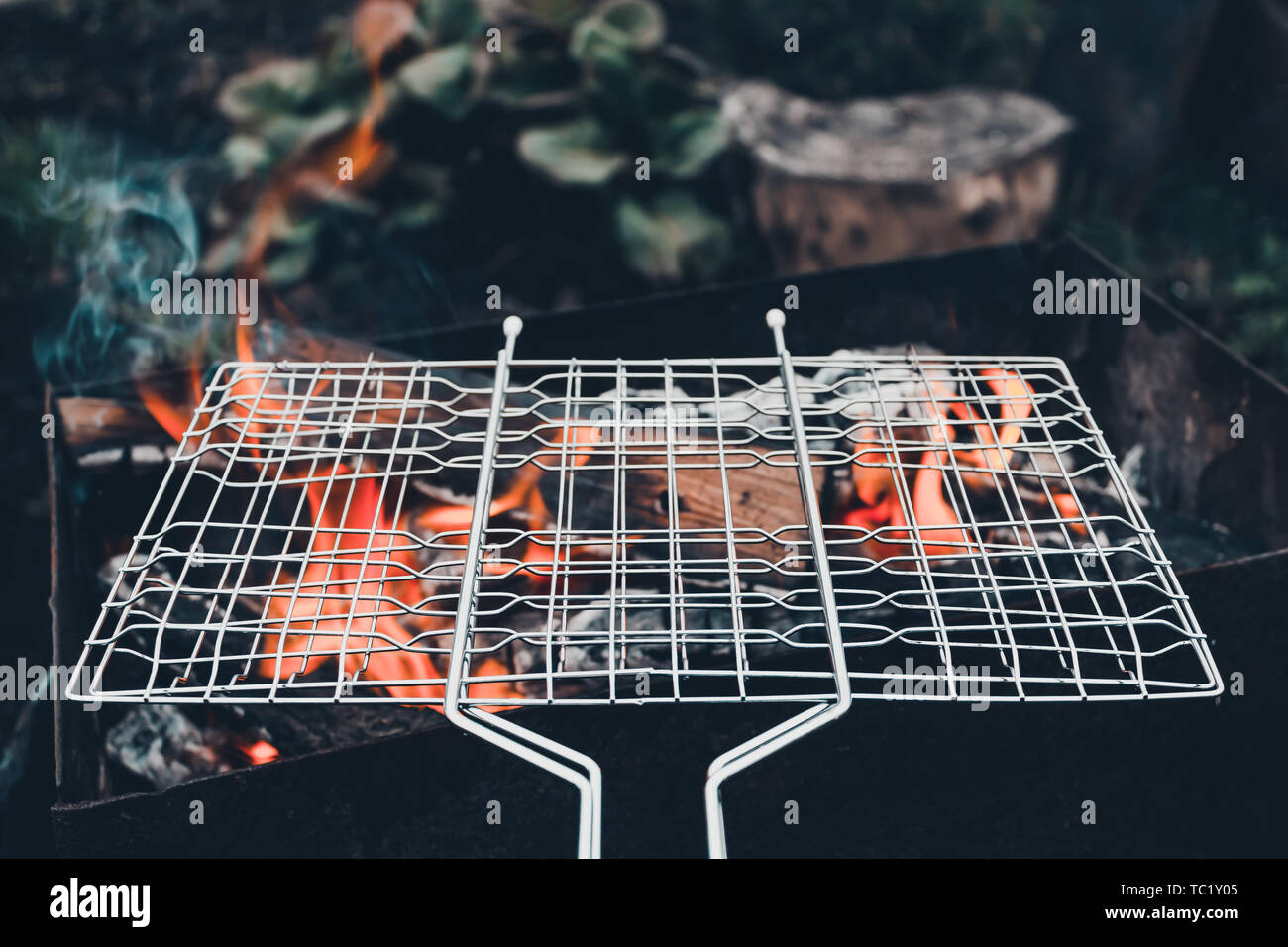 Metal grill on open fire. Cooking barbecue at picnic Stock Photo Alamy