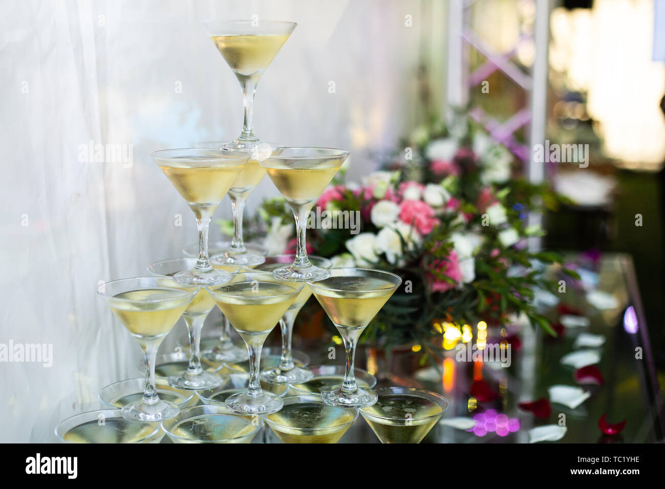 Champagne glasses standing in a tower at the party. Selective focus