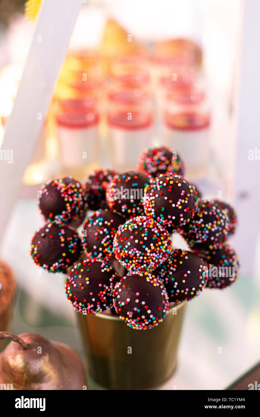 Candy bar. Sweets on a stick with sprinkles. Selective focus. Stock Photo