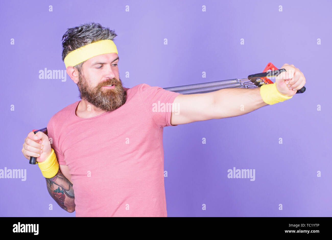 Sportsman training stretching expander. Man bearded athlete exercising ...