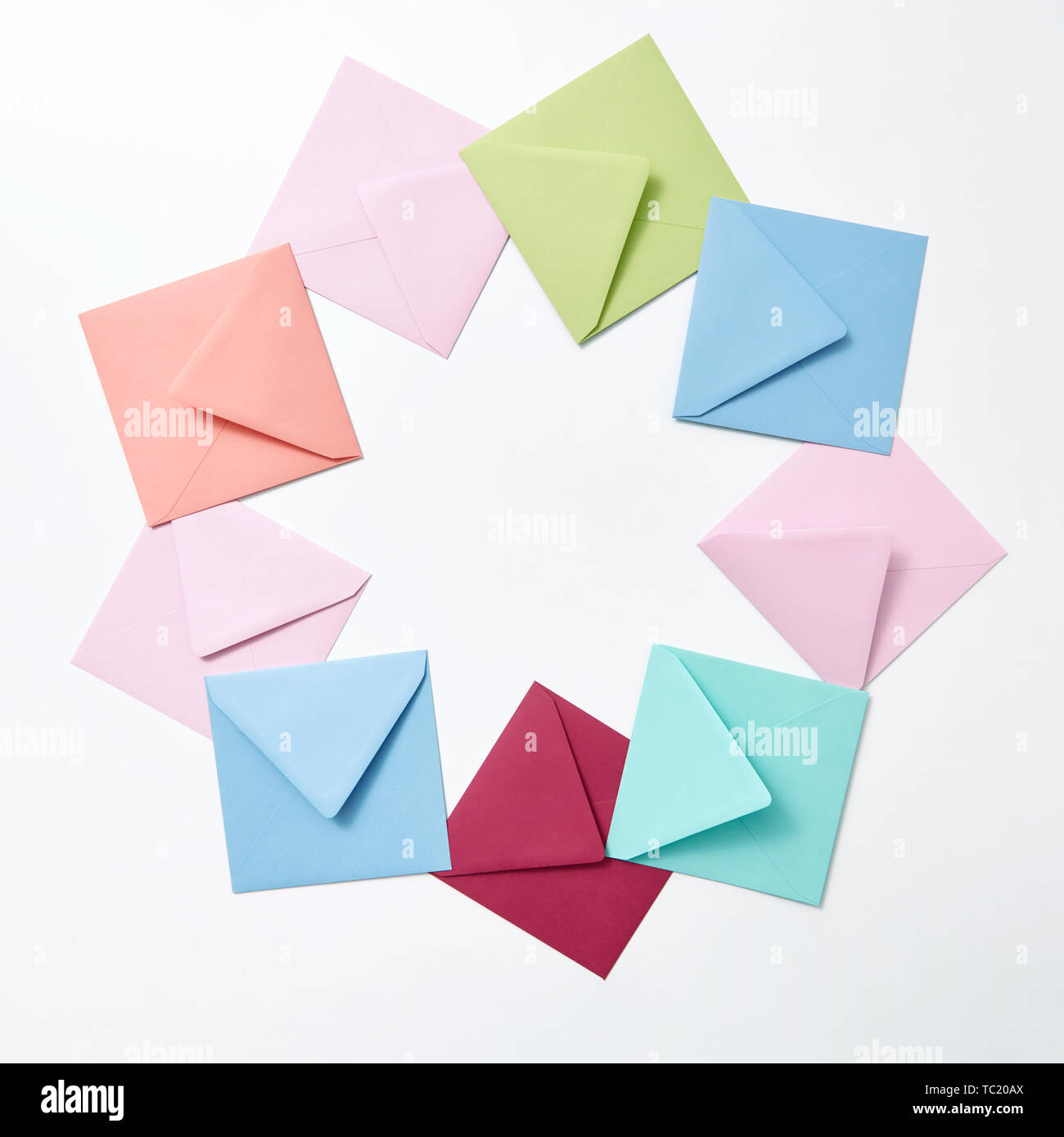 Round frame of colored craft blank envelopes on a light background ...
