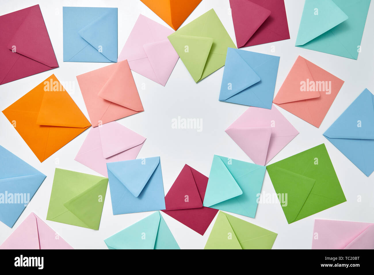 Colorful frame from empty handmade envelopes on a light background. Stock Photo