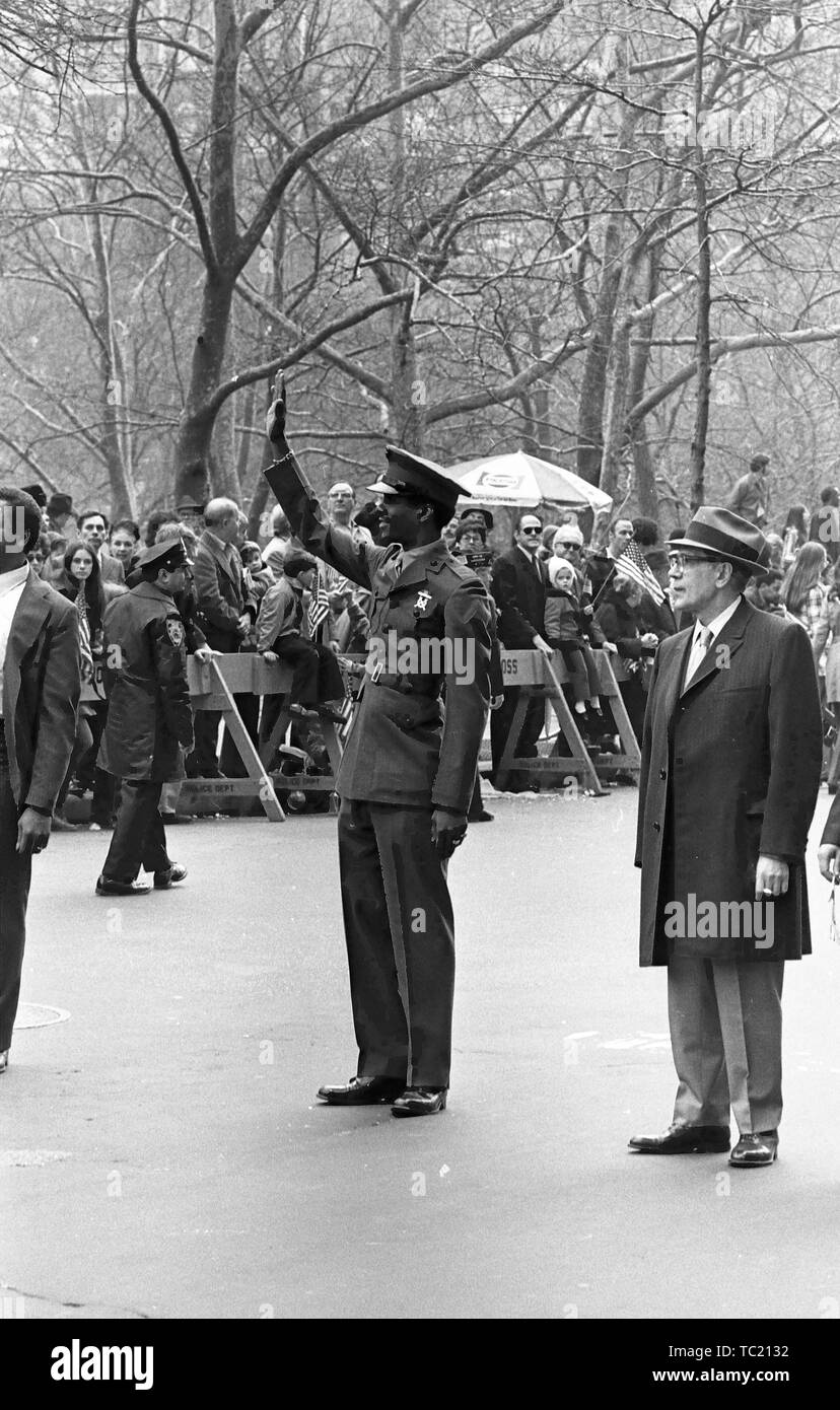 A man in uniform stands in profile, and raises his hand to wave or salute while participating in the Home With Honor Parade, New York City, New York, March 31, 1973. () Stock Photo