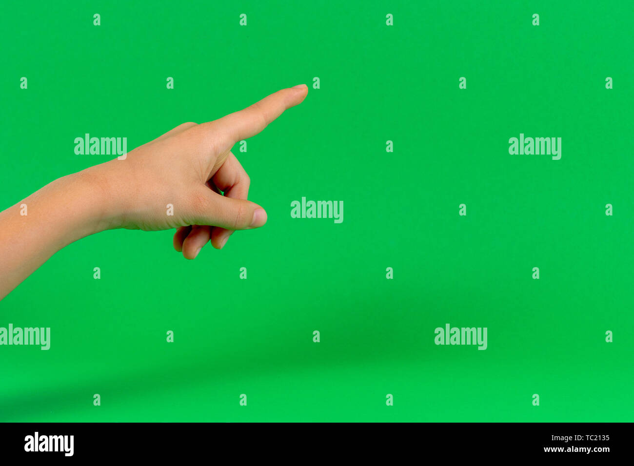Hand finger point on light green background Stock Photo