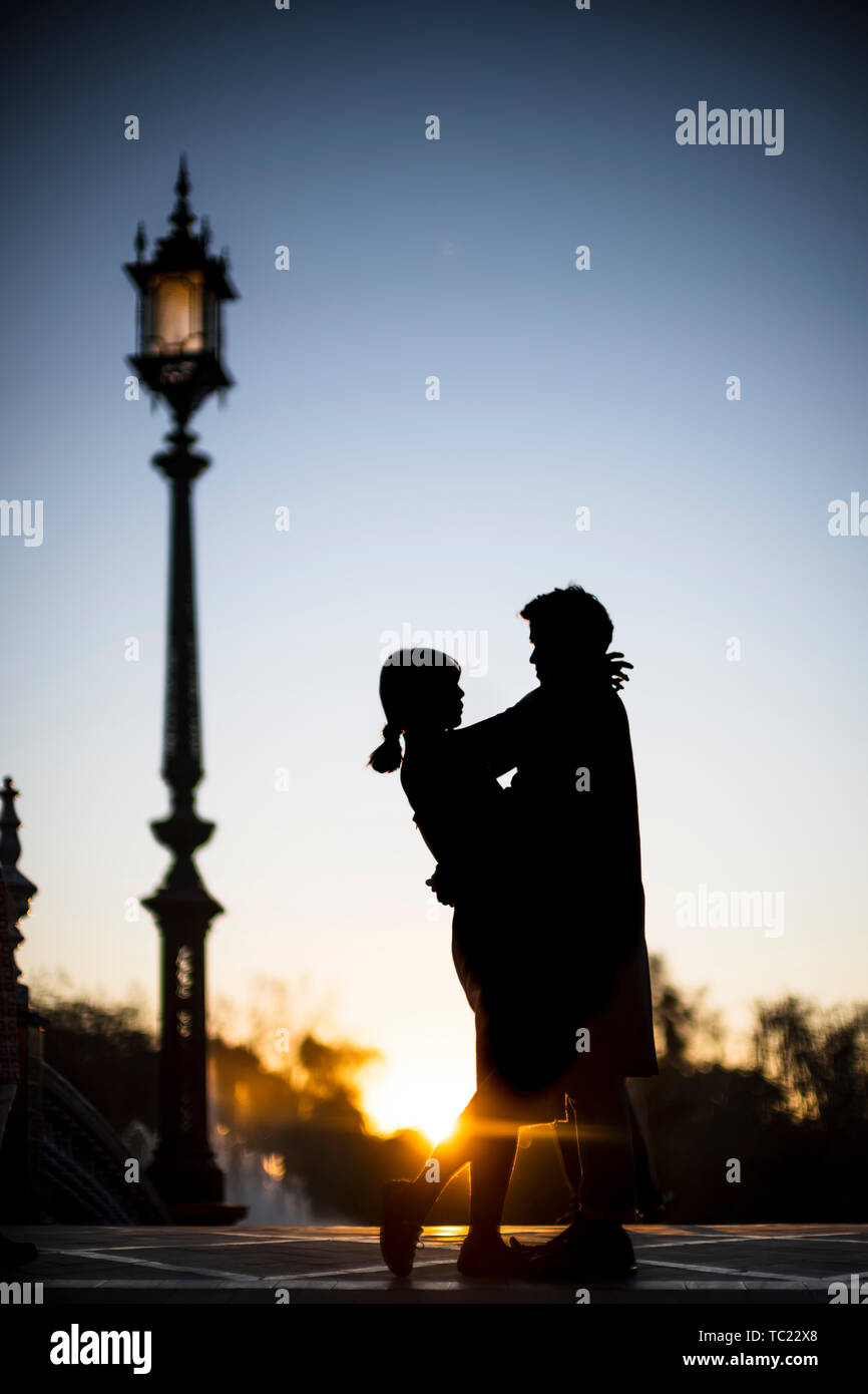 Young couple embracing at sunset, Plaza de España, Seville, Spain. Stock Photo