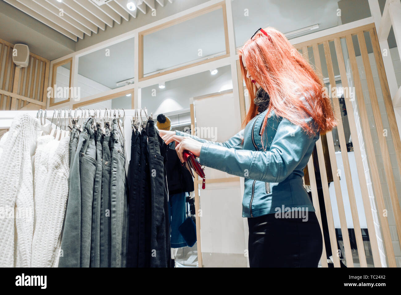 Young Happy Girl Buying Pants In Clothing Store Stock Photo, Picture and  Royalty Free Image. Image 44788038.