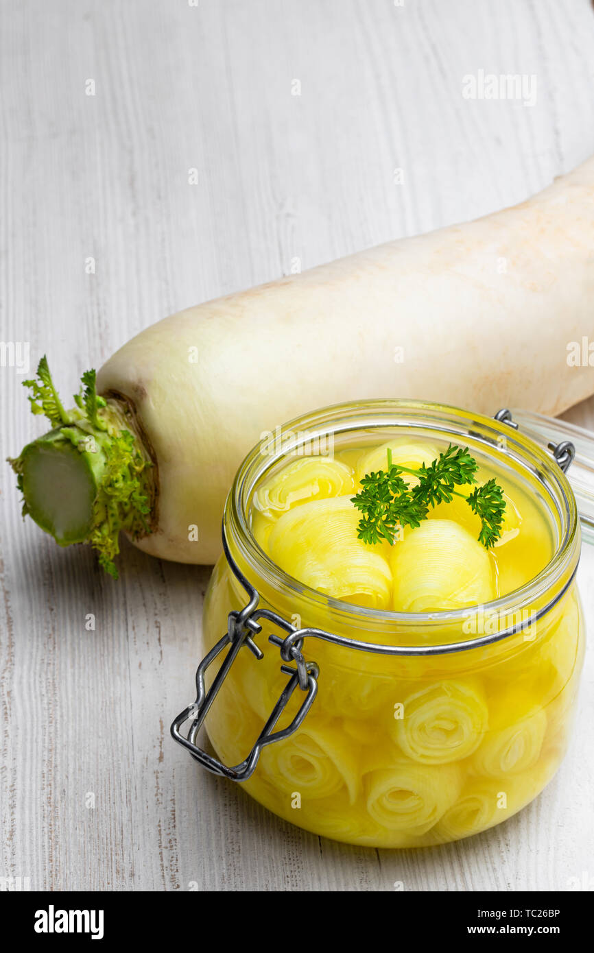 Marinated daikon on white wooden table Stock Photo Alamy