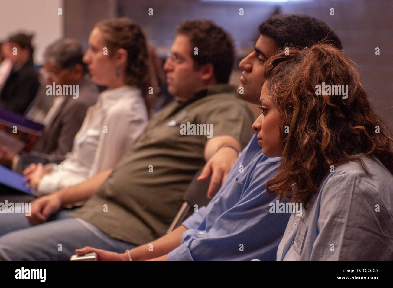 Profile shot of seated people, from the waist up, likely during an admission event at the Johns Hopkins University, Baltimore, Maryland, April 10, 2004. From the Homewood Photography Collection. () Stock Photo