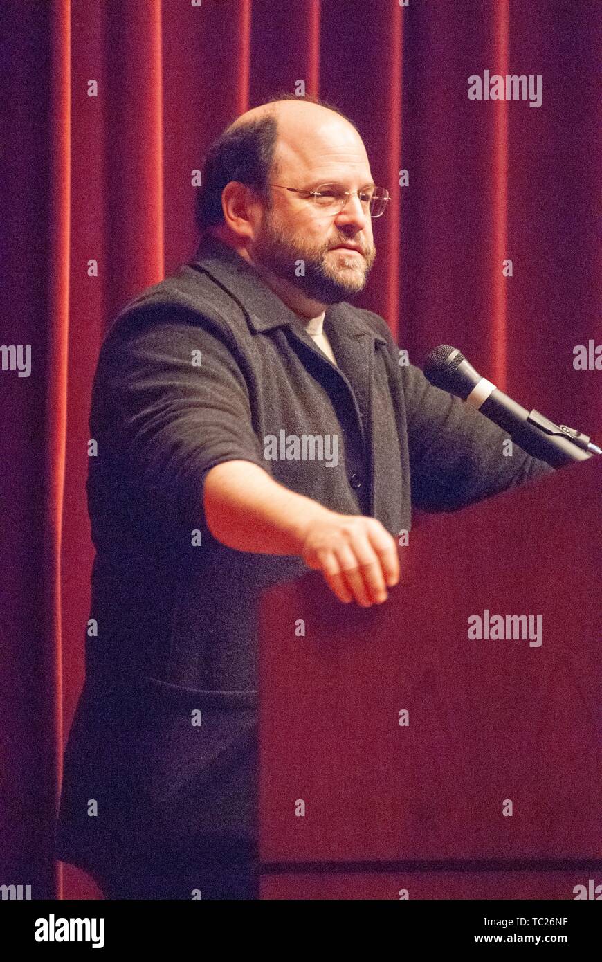 Three-quarter profile shot of actor and comedian Jason Alexander standing behind a podium during a Milton S Eisenhower Symposium, Homewood Campus of Johns Hopkins University, Baltimore, Maryland, October 13, 2006. From the Homewood Photography Collection. () Stock Photo