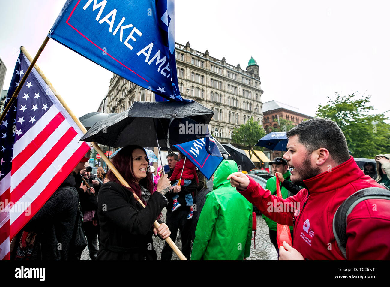 Jayda Fransen (left) former deputy leader of Britain First, in a heated discussion as she stages a corner protest with supporters at a 'Stop Trumpism' rally hosted by ExAct: Expat Action Group NI, at Belfast City Hall. Stock Photo