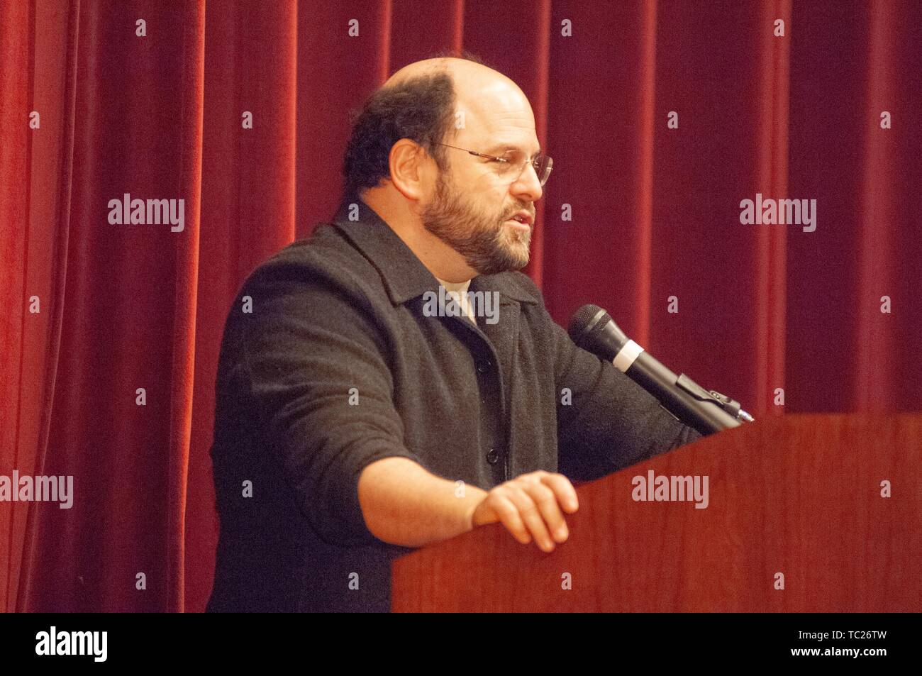 Profile shot of actor and comedian Jason Alexander speaking from a podium during a Milton S Eisenhower Symposium, Homewood Campus of Johns Hopkins University, Baltimore, Maryland, October 13, 2006. From the Homewood Photography Collection. () Stock Photo