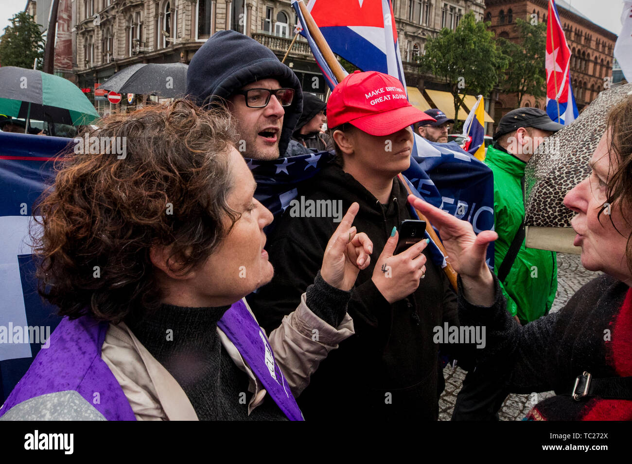 RETRANSMITTED CORRECTING SPELLING OF CUMMINGS Wayne Cummings (second from left) with his partner former Belfast Councillor Jolene Bunting (second from right) speaking with a steward and a person who attend the gathering during a corner protest at a 'Stop Trumpism' rally hosted by ExAct: Expat Action Group NI, at Belfast City Hall. Stock Photo